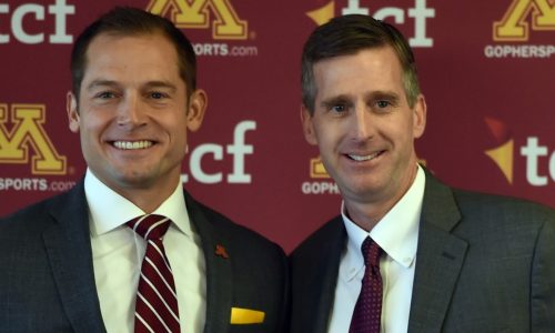 Gophers AD Mark Coyle stands behind football coach P.J. Fleck