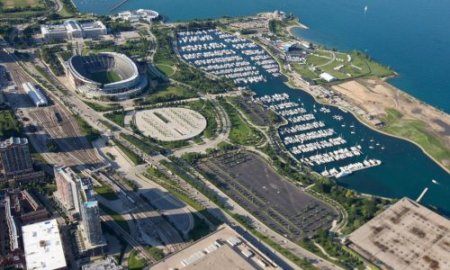 Report: Bears mulling Soldier Field parking area as new stadium site. Meanwhile, talks resume with schools over Arlington Heights location.