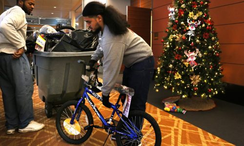 Workers sort gifts at Toys For Tots distribution center