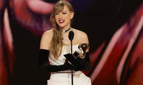 Taylor Swift wins album of the year at the Grammy Awards for the fourth time, setting a new record