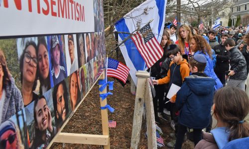 Newton residents gather to rehang Israel hostage posters after vandalism incident