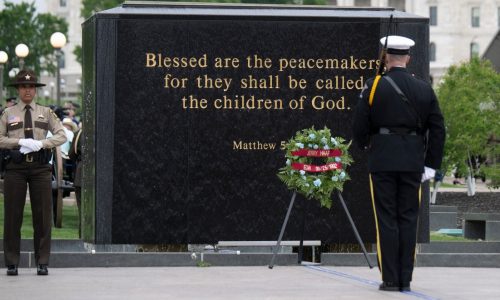 Families of two fallen Burnsville officers add their names to memorial flag