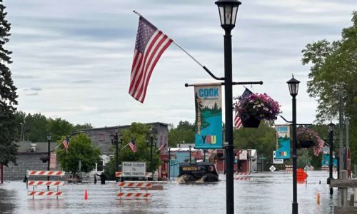 River floods in northeastern Minnesota community of Cook, submerging downtown