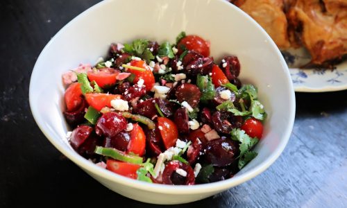 Grilled spiced chicken with sweet cherry and tomato salad makes quick, easy summer delight