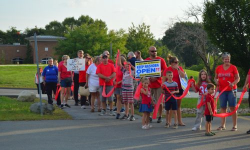 Hundreds form human chain around NVMC in show of solidarity ahead of closure