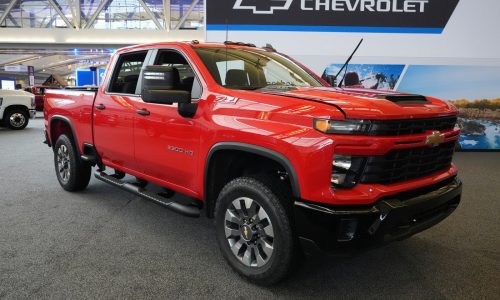 General Motors lays off about 1,000 workers, cutting costs to compete in a crowded automobile market