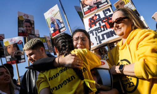 Hamas frees 8 more hostages but Israel puts prisoner release on hold after a chaotic handover