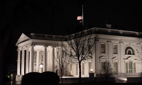 Why are US flags being flown at half-staff on Inauguration Day?