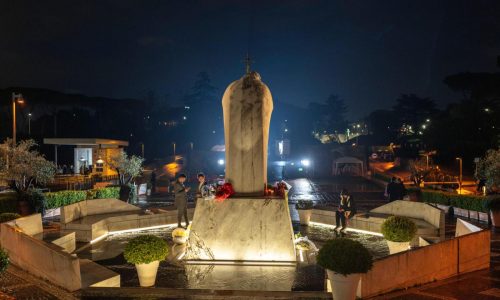 Pope Francis sits upright in an armchair as Argentines in Rome pray for his recovery