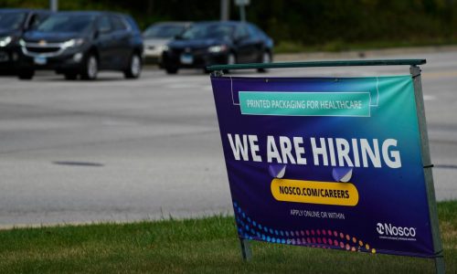 The number of Americans seeking jobless benefits falls as employers continue to hold on to workers