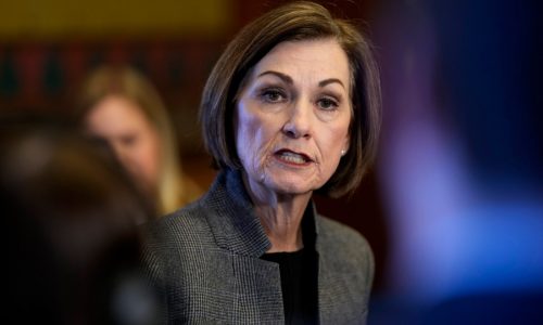 Iowa’s governor signs a bill removing gender identity protections from the state’s civil rights code