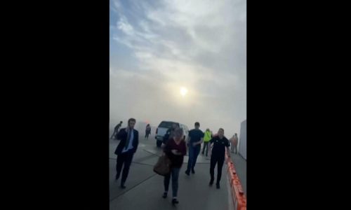 American Airlines Boeing 737 catches fire after landing at Denver airport; 12 people taken to hospitals with minor injuries
