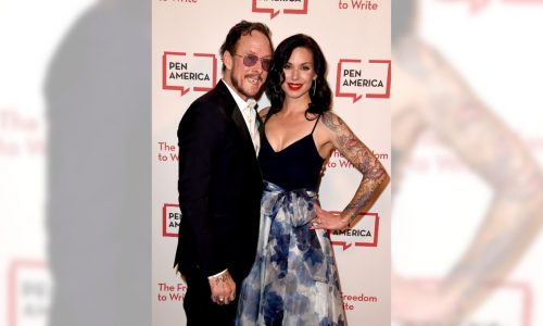 Author, wife of Weezer bassist arrested after being shot by police who say she pointed a gun at them