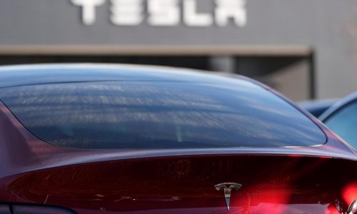 Tesla under investigation after parents say faulty door handles trapped their kids in the back