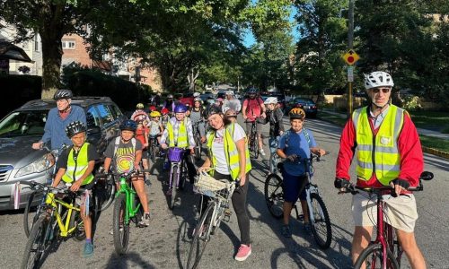 From a few to more than 350, children and parents ride together to school as a ‘bike bus’