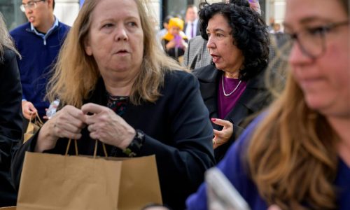 Photos of Americans turning to food pantries as shutdown drags on
