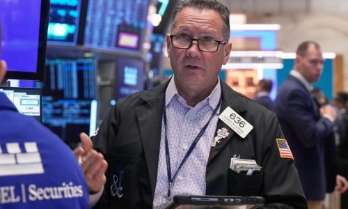 Wall Street hangs near its records as the battle to buy Warner Bros. heats up