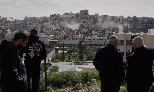 Palestinians watch as Israeli bulldozers claw down their West Bank homes