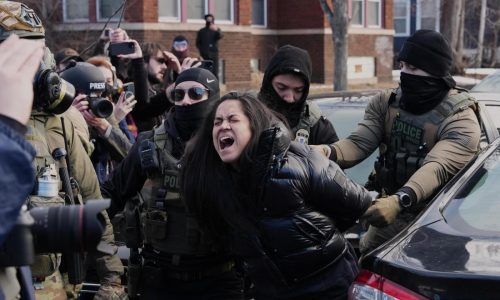 Federal immigration agents filmed dragging a woman from her car in Minneapolis