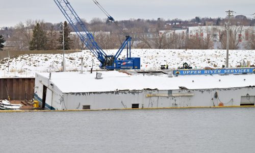 Maintenance barge on the Mississippi River is partially submerged